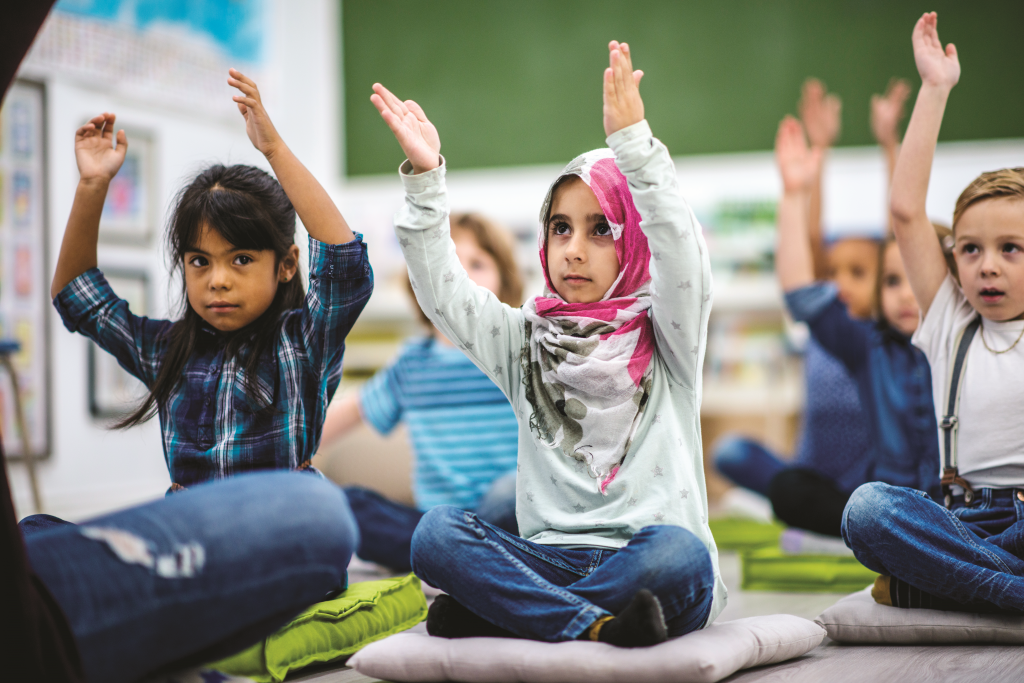 Muslim child with hands raised